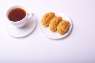 Obraz na płótnie Canvas Croissants and tea cup on white background