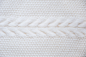 Fototapeta na wymiar White knitted texture. Knitting braids. Beautiful background.