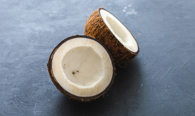 Sliced coconut on a dark table. Flat lay scene for copy space and background.