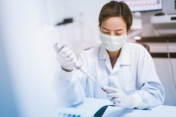 Naklejka premium Young scientist female working at the medical laboratory