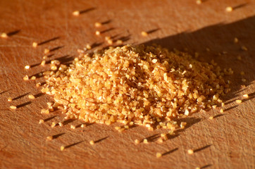 Close-up wheat groats on wooden board, photo