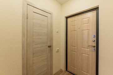 Fototapeta premium Russia, Omsk- October 18, 2019, 2019: interior room apartment. standard repair decoration in hostel. room doors, repair corridor