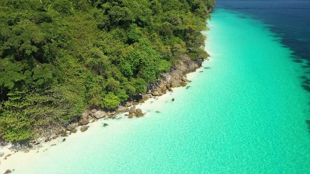 Aerial view of ocean waves, Beautiful tropical beach and rocky coastline and beautiful forest. Nyaung Oo Phee Island Myanmar