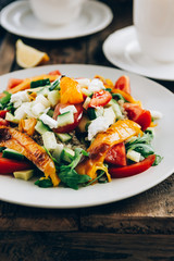Detox healthy dinner from Quinoa Salad with vegetables such as cucumbers, cherry tomatoes, pepper and goat cheese. Vegetarian food.