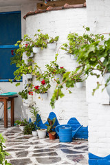 Fototapeta na wymiar traditional white Greek house with flowers on walls