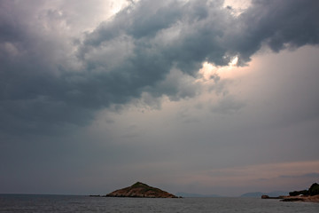 Panoramic view of an islet on a cloudy summer day.