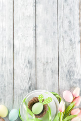 Easter holiday table setting with rabbits and eggs