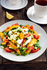 Detox healthy dinner from Quinoa Salad with vegetables such as cucumbers, cherry tomatoes, pepper and goat cheese. Vegetarian food.