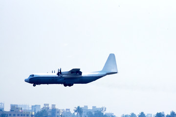 Fototapeta premium Side view of airplane landing on airport runway
