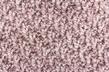 Knitted background. Knitted texture. A sample of knitting from wool. Knitting Pattern.