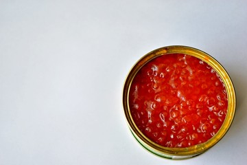 The large jar of red caviar with the spoon