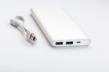 Power Bank for charging your smartphone on a white background. Universal external battery for gadgets free space and minimalistic composition.