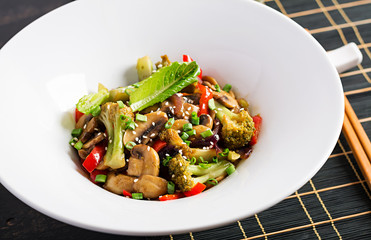 Stir fry vegetables with mushrooms, paprika, red onions and broccoli. Healthy food. Asian cuisine.