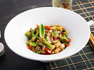 Stir fry vegetables with mushrooms, paprika, red onions and broccoli. Healthy food. Asian cuisine.