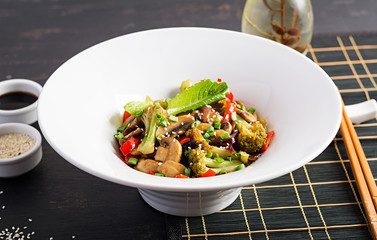 Stir fry vegetables with mushrooms, paprika, red onions and broccoli. Healthy food. Asian cuisine.