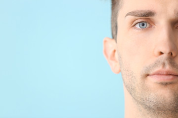 Fototapeta premium Handsome young man on color background, closeup. Plastic surgery concept