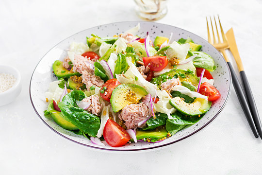 Tuna fish salad with lettuce, cherry tomatoes, avocado and red onions. Healthy food. French cuisine.