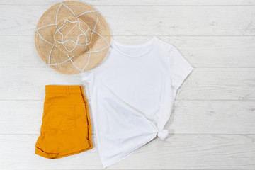 White closeup t shirt mock up flat lay on white wooden background. Top view and copy space. Mockup...