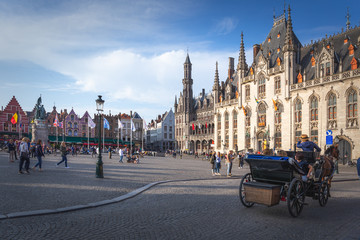 Fototapeta premium Horse and trap taking tourists for a city tour, Markt Square, Bruges, Belgium