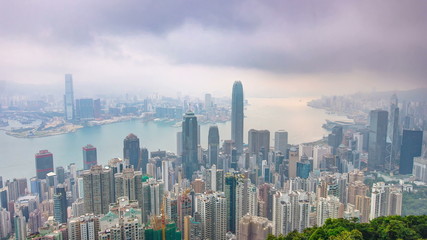 The famous view of Hong Kong from Victoria Peak night to day timelapse. Taken before sunrise with colorful clouds over Kowloon Bay.