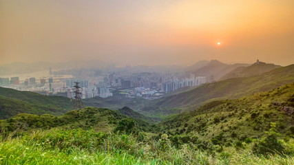 Cityscape of Hong Kong as viewed atop Kowloon Peak with sunset timelapse with Hong kong and Kowloon below