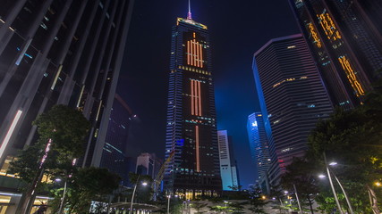 Night view hyperlapse of modern city in park with fountain and skyscrapers around. Time lapse. Hong Kong