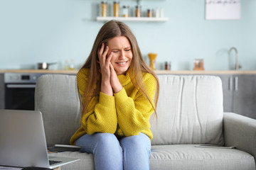 Worried young woman in debt at home