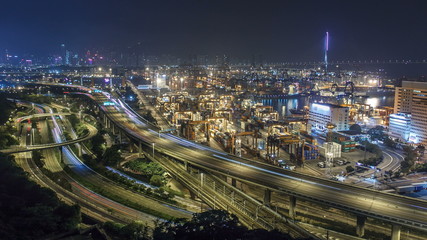 Hong Kong Skyline and Container Terminal at Night timelapse - Hong Kong Kwai Tsing Container Terminals is one of the busiest ports in the world.