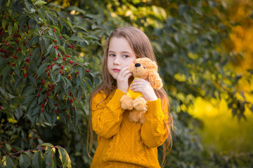  Girl, autumn, ginger color jumper, toy dog, sad