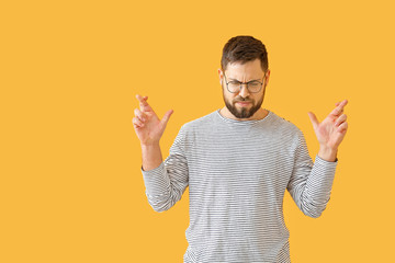 Worried young man on color background