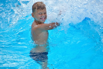 Fototapeta na wymiar Baby boy on a water Board. Stay in the water Park in the summer.
