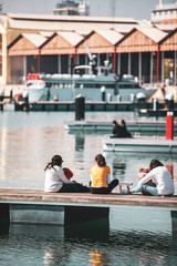 Single parent mothers watching the sunset in the harbor