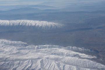 Fototapeta na wymiar Snowed mountain tops aerial landscape view.