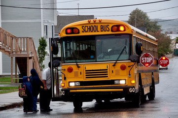 Fototapeta na wymiar School Bus Stop, Father with Children Boarding