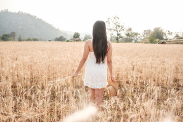 The girl travels on the meadow in the evening