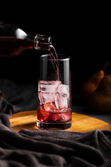 Red wine pouring in glass front view