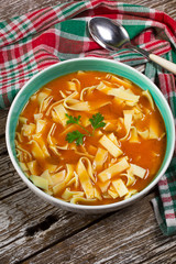 Tomato soup with noodles in a bowl.