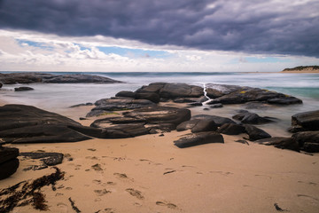 Dark clouds and epic waves beach Australia