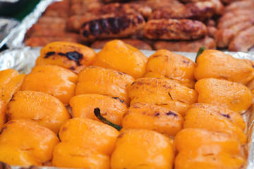 Grilled yellow peppers, closeup. Street food at vegan festival. Grilled vegetables at street food festival.