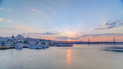 Naklejka na ściany i meble Passenger Ferries in the Golden Horn at sunset timelapse, Istanbul skyline, Turkey