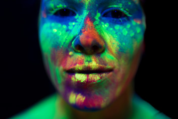 Close-up view of woman with fluorescent make-up