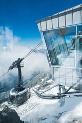 The cableway is arriving to Punta Helbronner station immersed in the clouds - obrazy, fototapety, plakaty