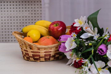 Fruit in a basket. Apple, bananas, oranges. Dietary nutrition.