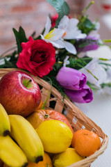 Fruit in a basket. Apple, bananas, oranges. Dietary nutrition.