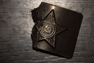 Nibbled Old belt buckle with a star from Soviet army uniform. 23 February. Russian military...