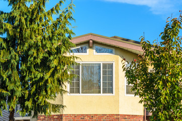 The top of the house or apartment building with nice window.