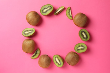 Flat lay with kiwi on pink background, top view