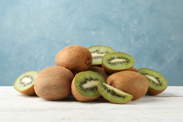 Ripe fresh kiwi on wooden table, close up and space for text