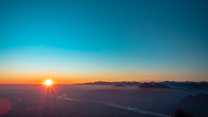 Fototapeta na wymiar Winter sunset from an alpine peak of Friuli-Venezia Giulia