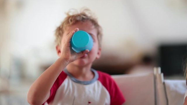 Child boy drinking beverage and then burping and belching out loud